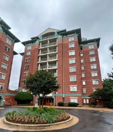 Brick mid-rise condo building in Northern Virginia with landscaped entry